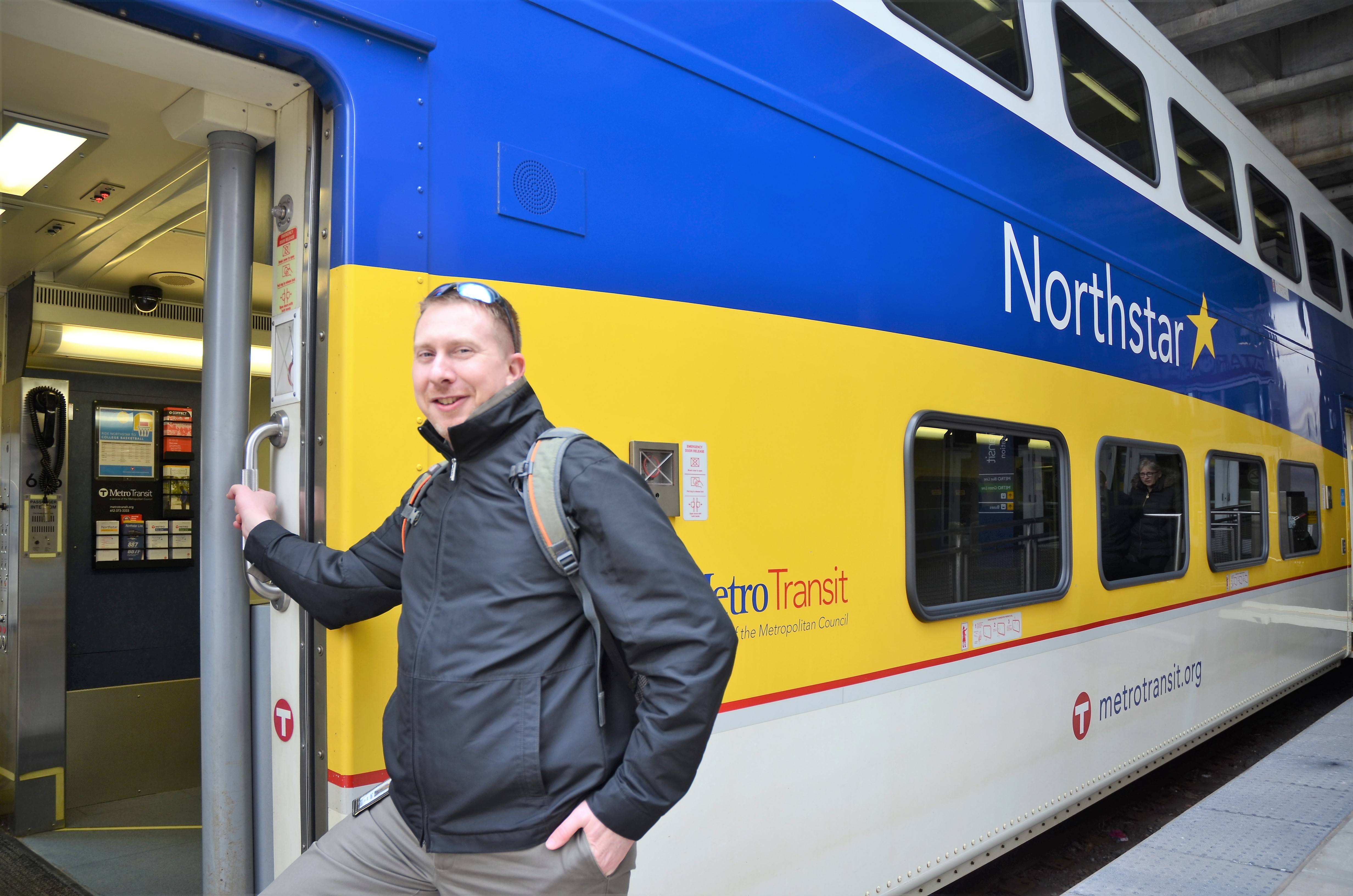 Associate Planner Clayton Watercott boards the Northstar Commuter Rail Line at Target Field Station in Minneapolis.