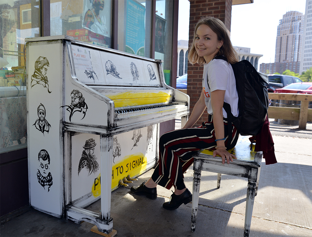 Alexandra Norwick with her "Voices on Transit" piano. 