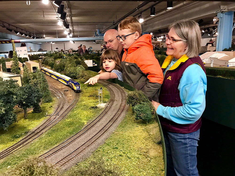 Maria Dierks of Elk River and her grandchildren admire miniature Northstar commuter rail operations and maintenance facility in Big Lake, Minn.