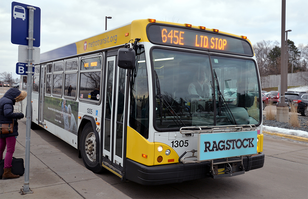 Customers board a Route 645 bus at the Louisiana Avenue Transit Center in St. Louis Park. 