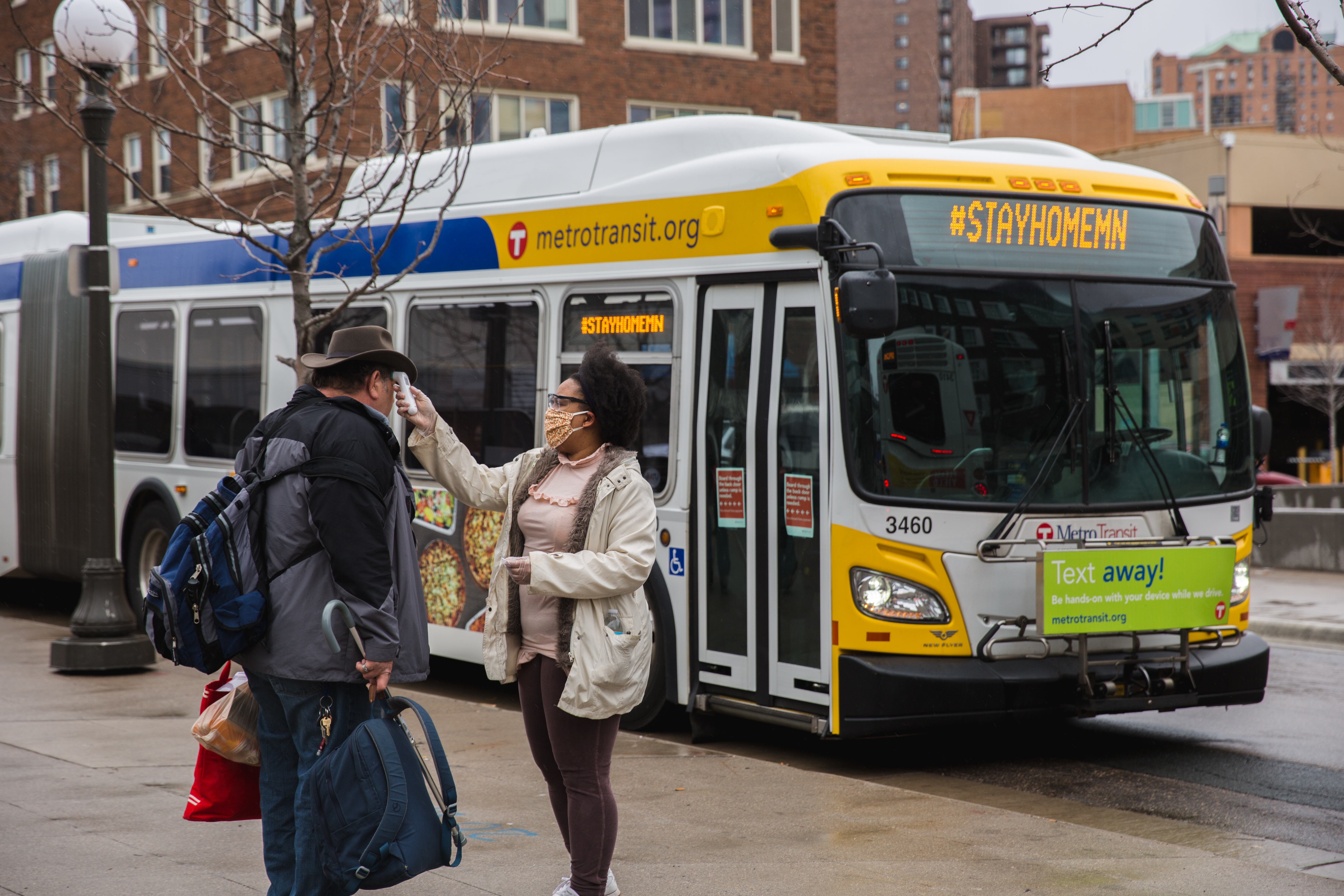 A person prepares to board a Metro Transit bus to be transported to a Saint Paul hotel.