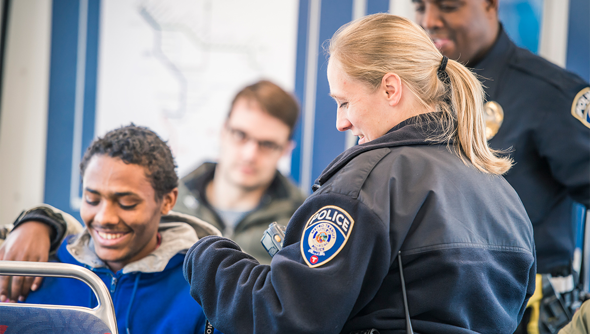 Photo of Metro Transit Police interacting with passengers on the Light Rail.